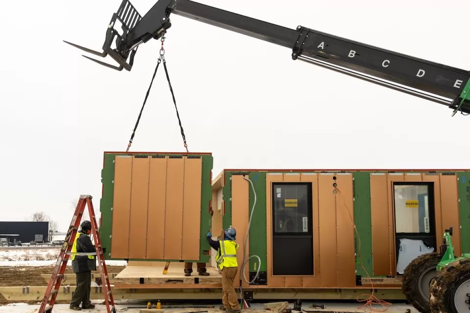 Modular housing being installed with crane.